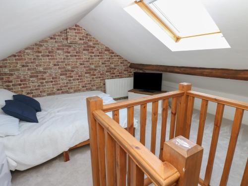 a attic bedroom with a bed and a skylight at Lonsdale Street in Workington