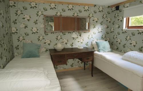 a room with two beds and a desk in it at Naturskönt boende med tillgång till båt in Vrigstad