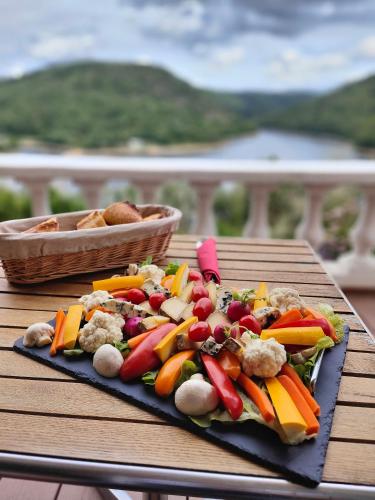 a plate of vegetables on a table on a table at Ma villa au bord de l'eau in Miremont