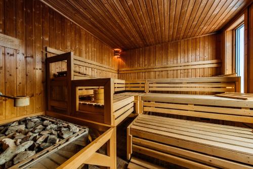 a sauna with wooden walls and wooden ceilings at Riva Del Sole Resort & SPA in Castiglione della Pescaia