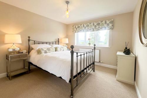 a bedroom with a bed and a window at Wellingtonia Cottage in Chirbury
