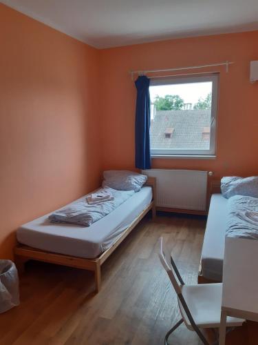 a small room with two beds and a window at 2-Rent Group Hostel Rooms&Apartments TUB19A in Munich