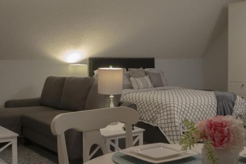 a living room with a bed and a couch at Beautiful Luxury Studio Suite in Lawrenceville