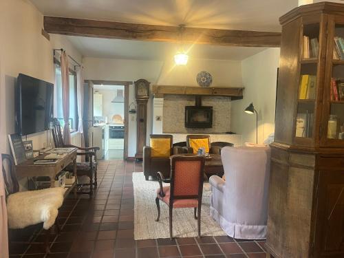 a living room with chairs and a couch and a table at Vakantiehuis Eksel in Hechtel-Eksel