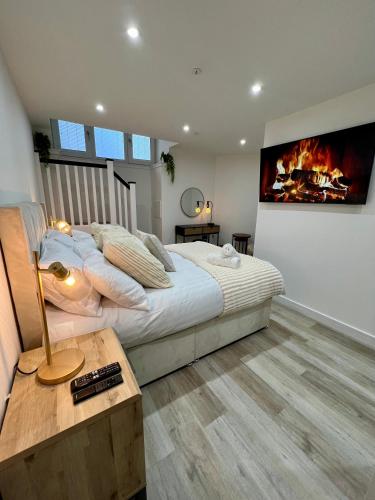a bedroom with a large bed and a fireplace at Edin Central 4 bedroom Apartment Fully Renovated in Edinburgh