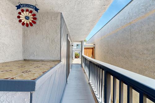 a balcony with a flower clock on the wall at Seaspray at Anacapa View in Port Hueneme