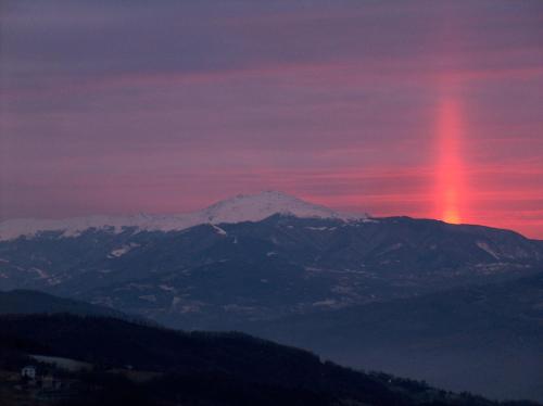 a rainbow in the sky over a mountain range at Albergo Ristorante Panoramic in Zocca