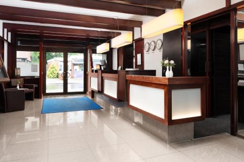 a lobby with a reception desk in a building at Best Western Hotel Heide in Oldenburg