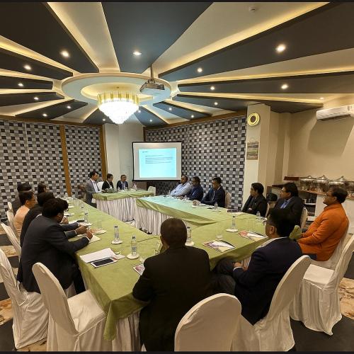 a group of people sitting around a table in a room at Hotel JP Hills Rishikesh in Rishīkesh