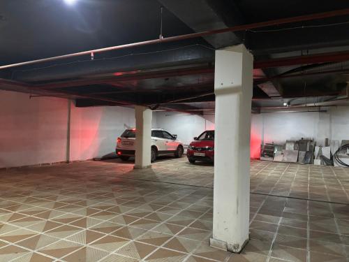 a parking garage with two cars parked in it at Hotel JP Hills Rishikesh in Rishīkesh