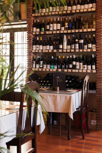 a room with a table and a bunch of bottles of wine at Hotel Palacio de Hemingway in Ronda