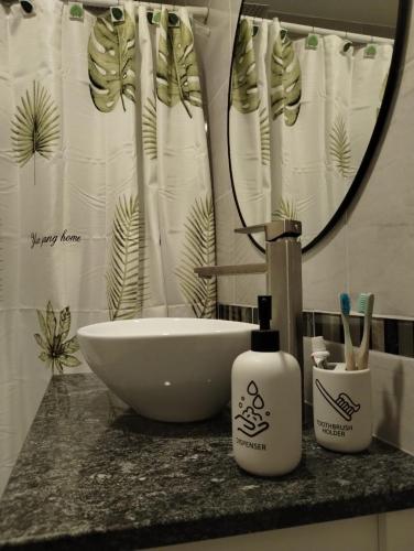 a bathroom counter with a sink and a mirror at Descanso en el Sur in Playa Unión