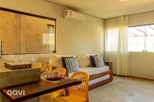 a living room with a couch and a table at Qavi - Casa com Piscina Privativa - Lambari 07 in Barra do Camaragibe