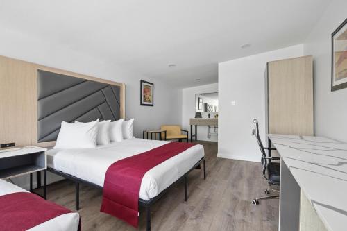 a hotel room with a bed and a desk at Harkness Brook Inn in Rockport