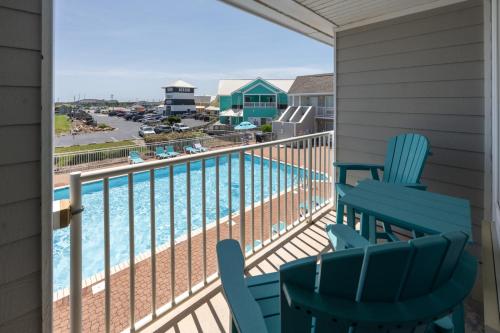 a balcony with chairs and a swimming pool at Villas of Hatteras Landing by KEES Vacations in Hatteras
