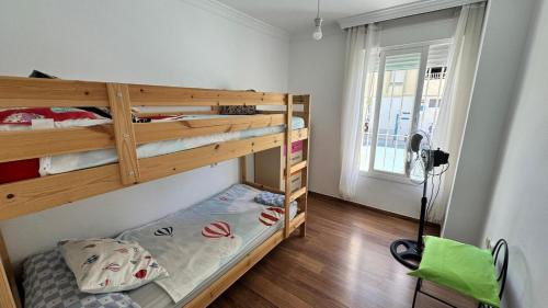 a bedroom with two bunk beds and a window at AMPLIO PISO EN CENTRO DE TORRE DEL MAR in Torre del Mar