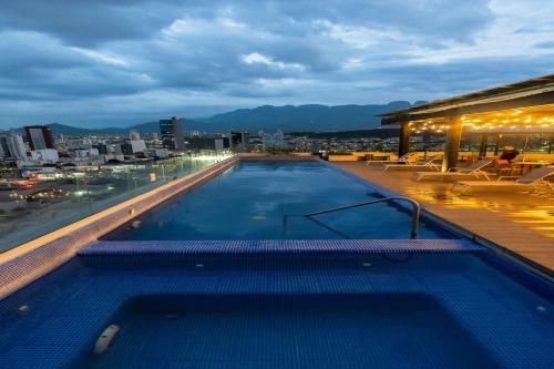 a swimming pool on the roof of a building at SJ Grand Hotel in Monterrey