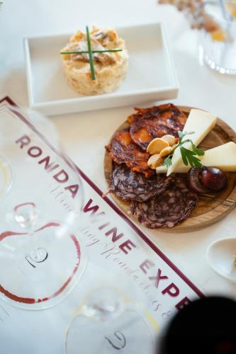 a table with two plates of food on it at Hotel Palacio de Hemingway in Ronda
