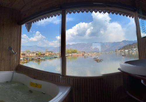 a window in a bathroom with a view of a lake at Smith palace group of houseboats in Srinagar