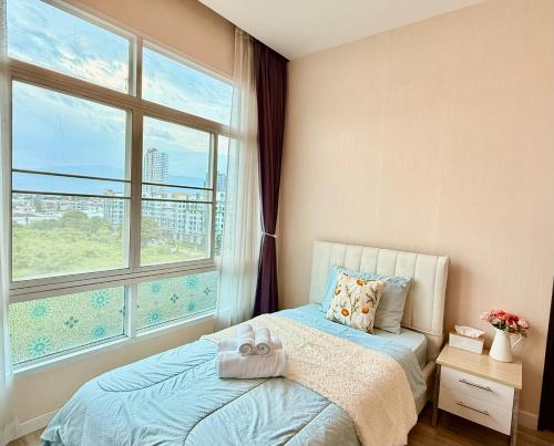 a bedroom with a bed and a large window at My hip Condominium 2 Bedrooms 2 baths comfy room for family in Chiang Mai