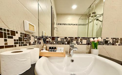 a bathroom with a white sink and a mirror at My hip Condominium 2 Bedrooms 2 baths comfy room for family in Chiang Mai