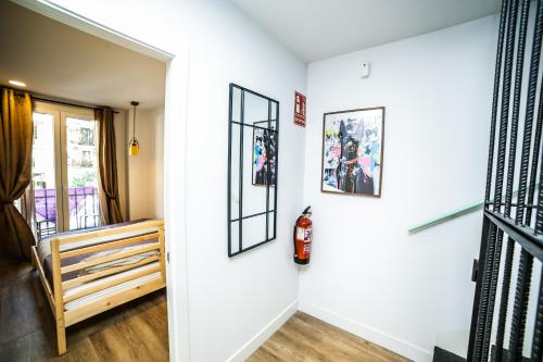 a room with white walls and a staircase with pictures on the wall at Hotel Maruja en Cascorro in Madrid