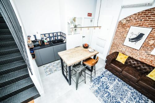 a living room with a table and a couch at Hotel Maruja en Cascorro in Madrid