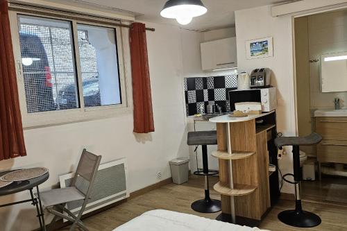 a small kitchen with a table and chairs in a room at Studio near the city center in Montpellier