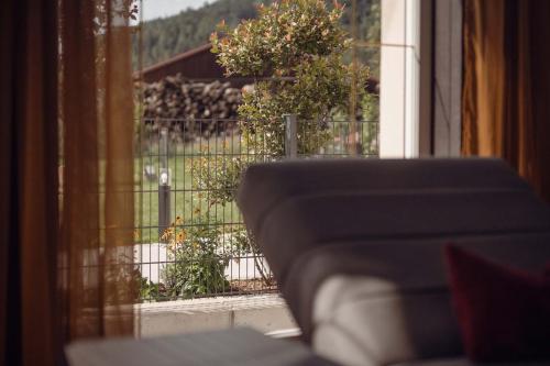 a view of a yard from a window with a fence at Posthotel Erlerwirt in Erl