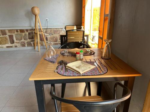 a wooden table with a plate of food on it at REBERO RESORT Ltd in Kigali