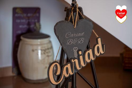 a sign that reads central bee caledified next to a jar at Cariad Boutique Bed & Breakfast in Cala del Moral