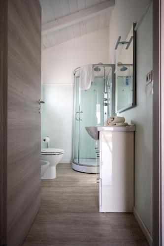 a bathroom with a sink and a toilet and a mirror at Agriturismo Macchia di Riso in Nova Siri Marina