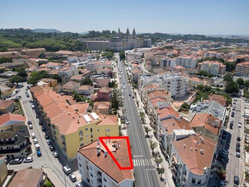 an aerial view of a city with a red building at Palace View Mafra in Mafra