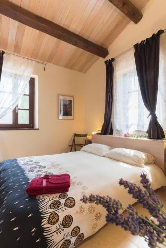 a bedroom with a large bed in a room at Antico Casale Tiravento in Passignano sul Trasimeno