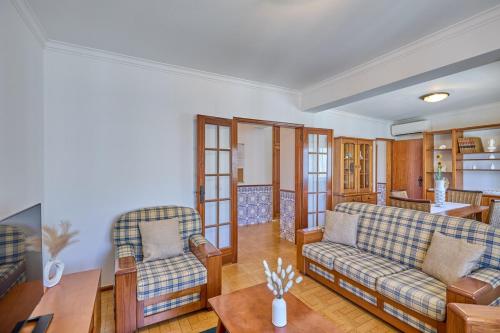 a living room with two couches and a table at Palace View Mafra in Mafra