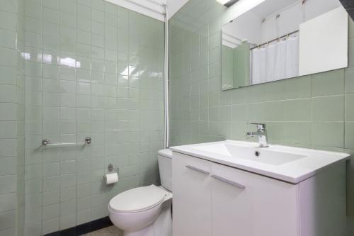 a bathroom with a white toilet and a sink at Estoril na praia in Estoril