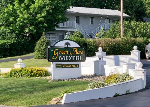 a sign for a green acre motel in front of a house at Green Acre Motel in Lake George