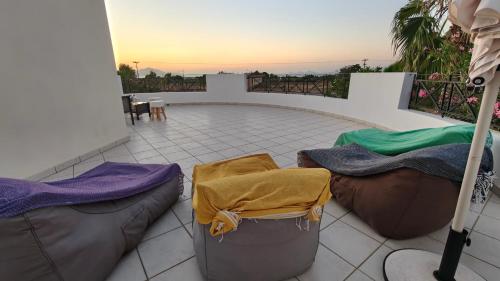 a patio with three bean bags and a table at Villa Aphrodity in Kos Town