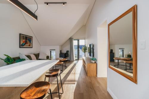 a kitchen and living room with a large mirror at St Francis Links - Elegant, Golfside & Coastal Apartment in St Francis Bay