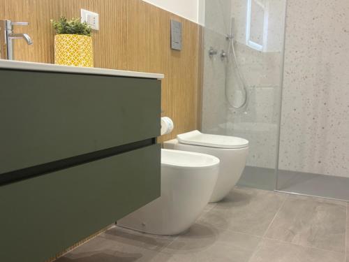 a bathroom with a white toilet and a shower at A due passi in Balestrate