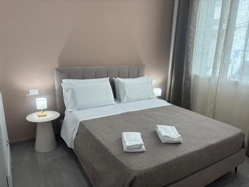 a bedroom with a bed with two towels on it at A due passi in Balestrate