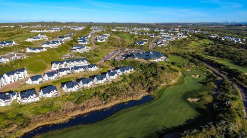 an aerial view of a golf course with homes at St Francis Links - Elegant, Golfside & Coastal Apartment in St Francis Bay