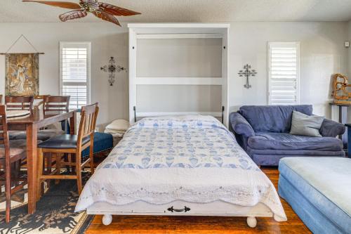 a bedroom with a bed and a dining room at Lakefront Granbury Home with Dock, Decks and Hot Tub! in Granbury