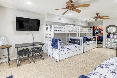 a room with three bunk beds and a desk at Lakefront Granbury Home with Dock, Decks and Hot Tub! in Granbury