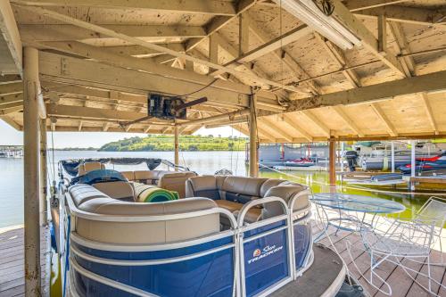 a boat sitting on the water in a dock at Lakefront Granbury Home with Dock, Decks and Hot Tub! in Granbury