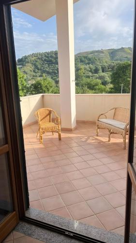 a balcony with two chairs and a couch at Villa Diamante in Diamante