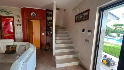 a stairway in a living room with a stair case at Villa Diamante in Diamante