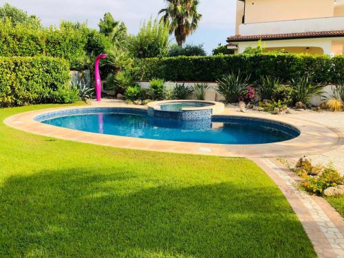 a pool in a yard with a fountain at Villa Diamante in Diamante