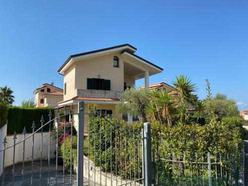 a house with a fence in front of it at Villa Diamante in Diamante