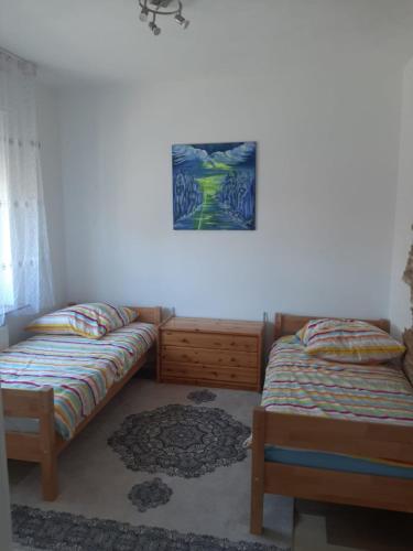 a bedroom with two beds and a picture on the wall at Wohnen auf Zeit HF in Herford